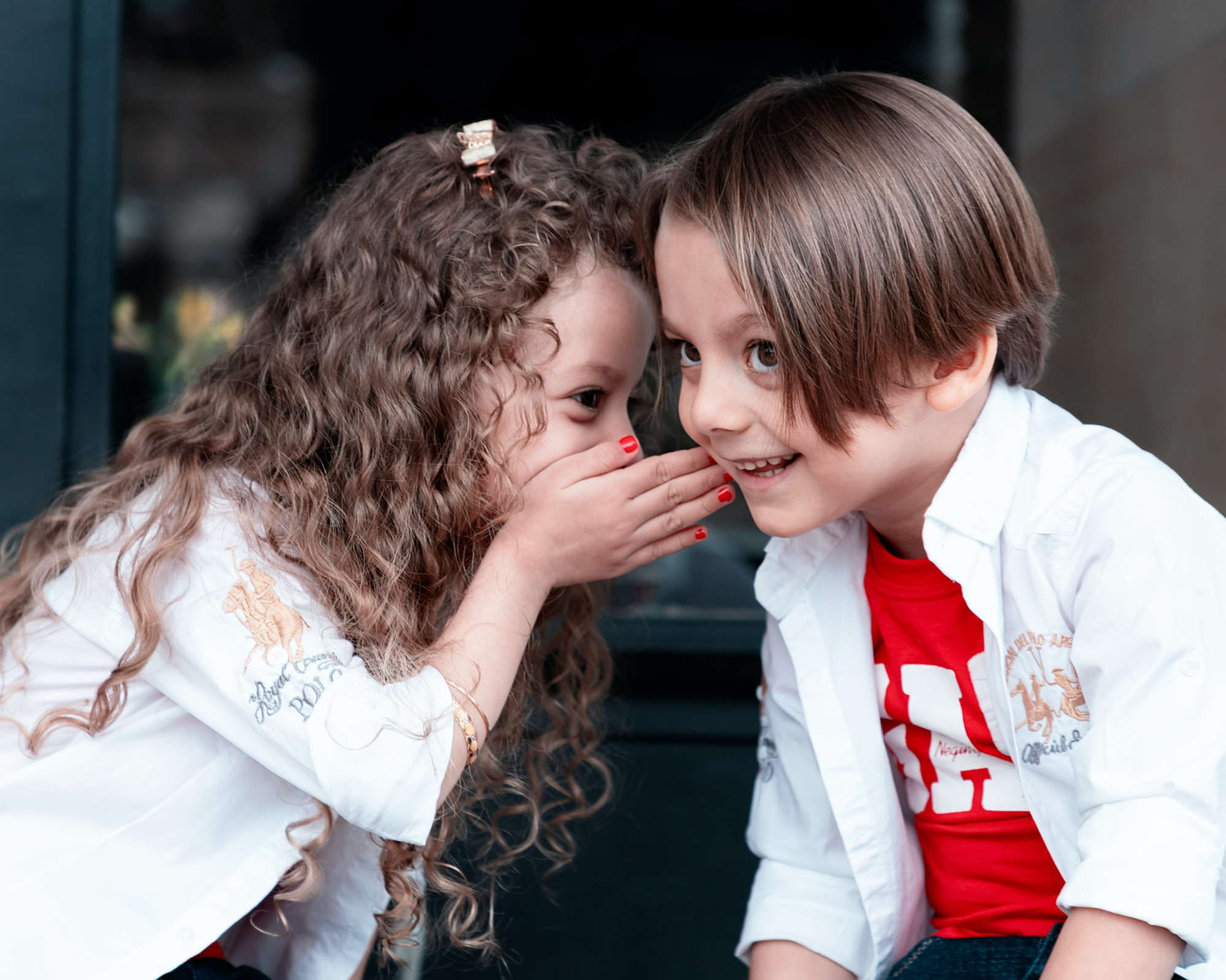 how-to-communicate-with-your-spouse Little girl whispering to a little boy.